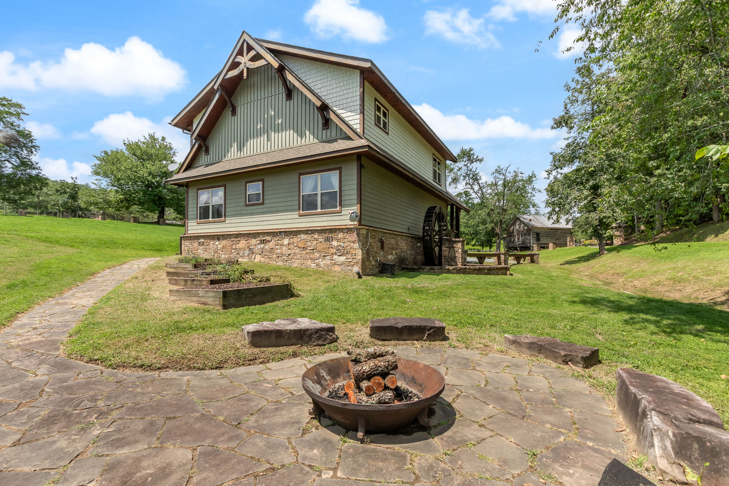 The Millhouse Lodge exterior with fire pit and farm grounds in Murphy, North Carolina